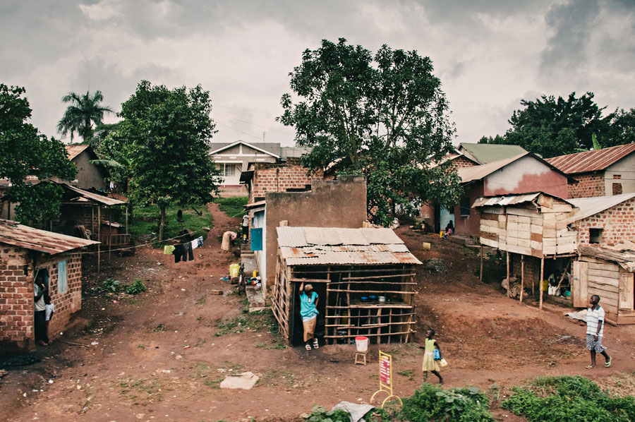 Rural Ugandan village with tin-roofed houses and red dirt roads near Bwindi