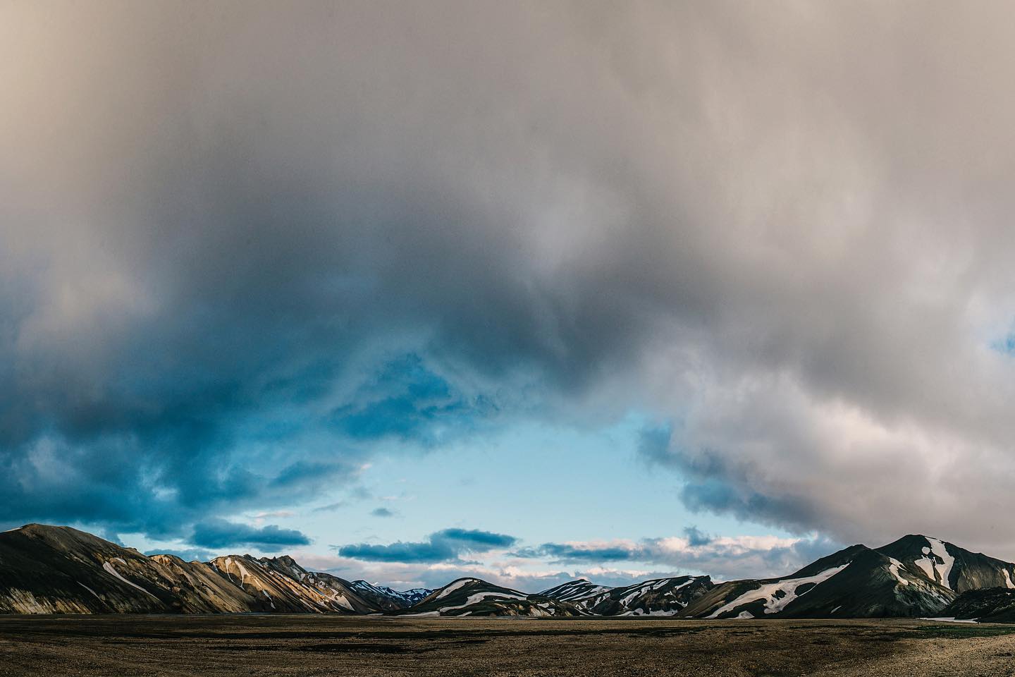Colourful rhyolite mountains of Landmannalaugar under dramatic storm clouds, Iceland highlands
