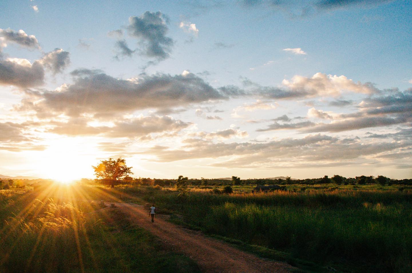 Dirt road stretching toward sunset in rural Malawi